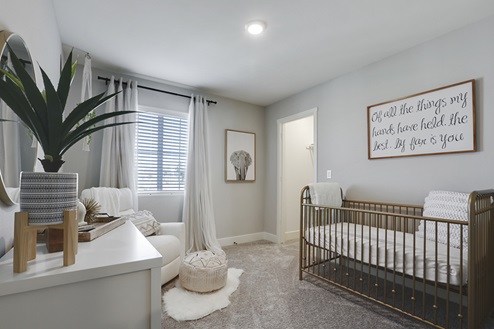 Spacious bedroom styled as nursery