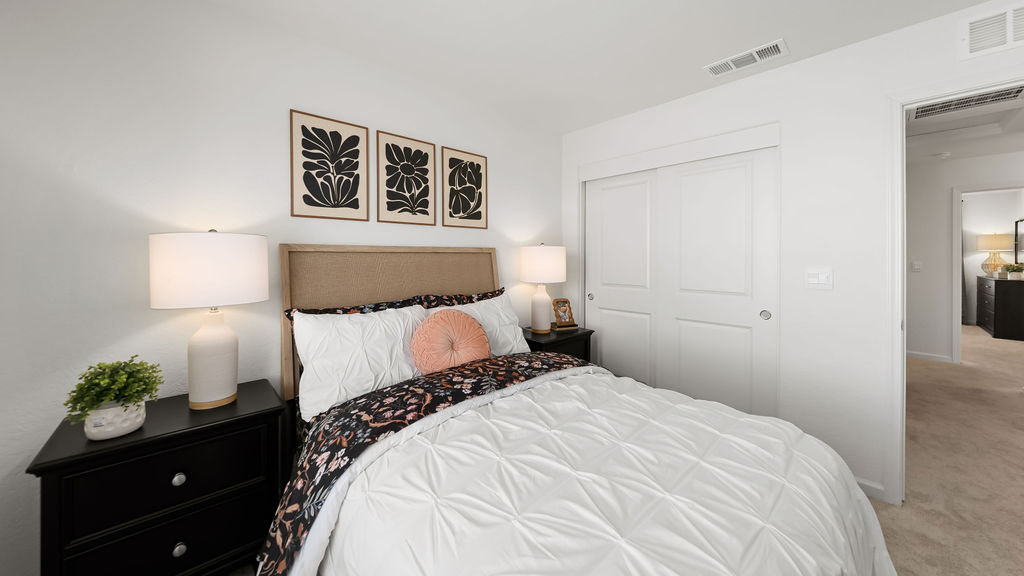 Bedroom with flower accents on the bed.
