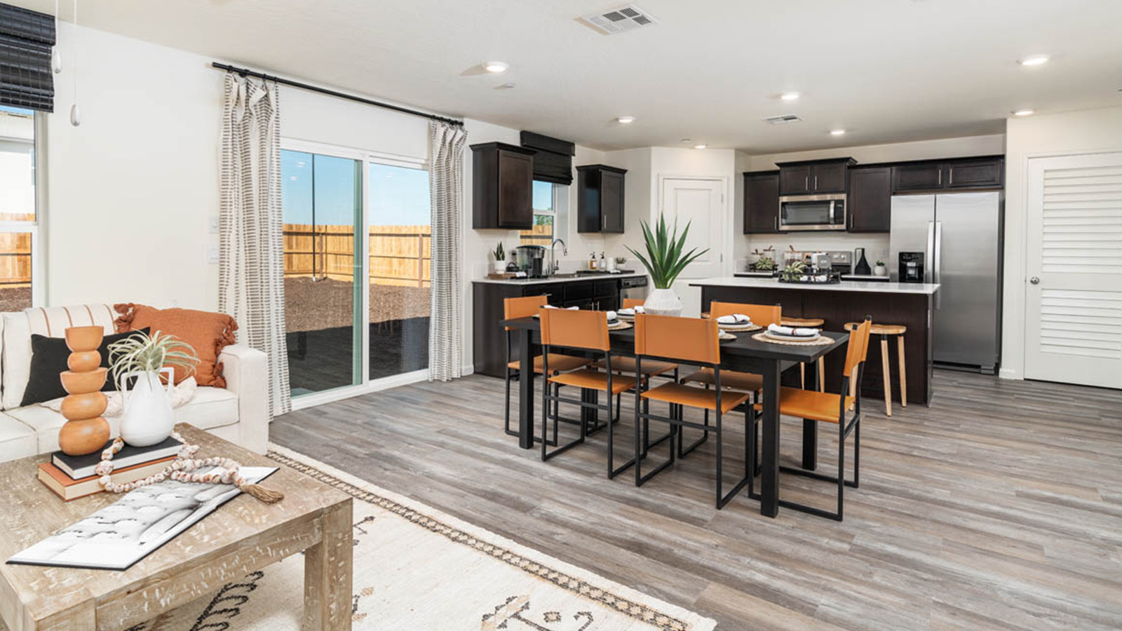 Kitchen with brown cabinets and a dining table.