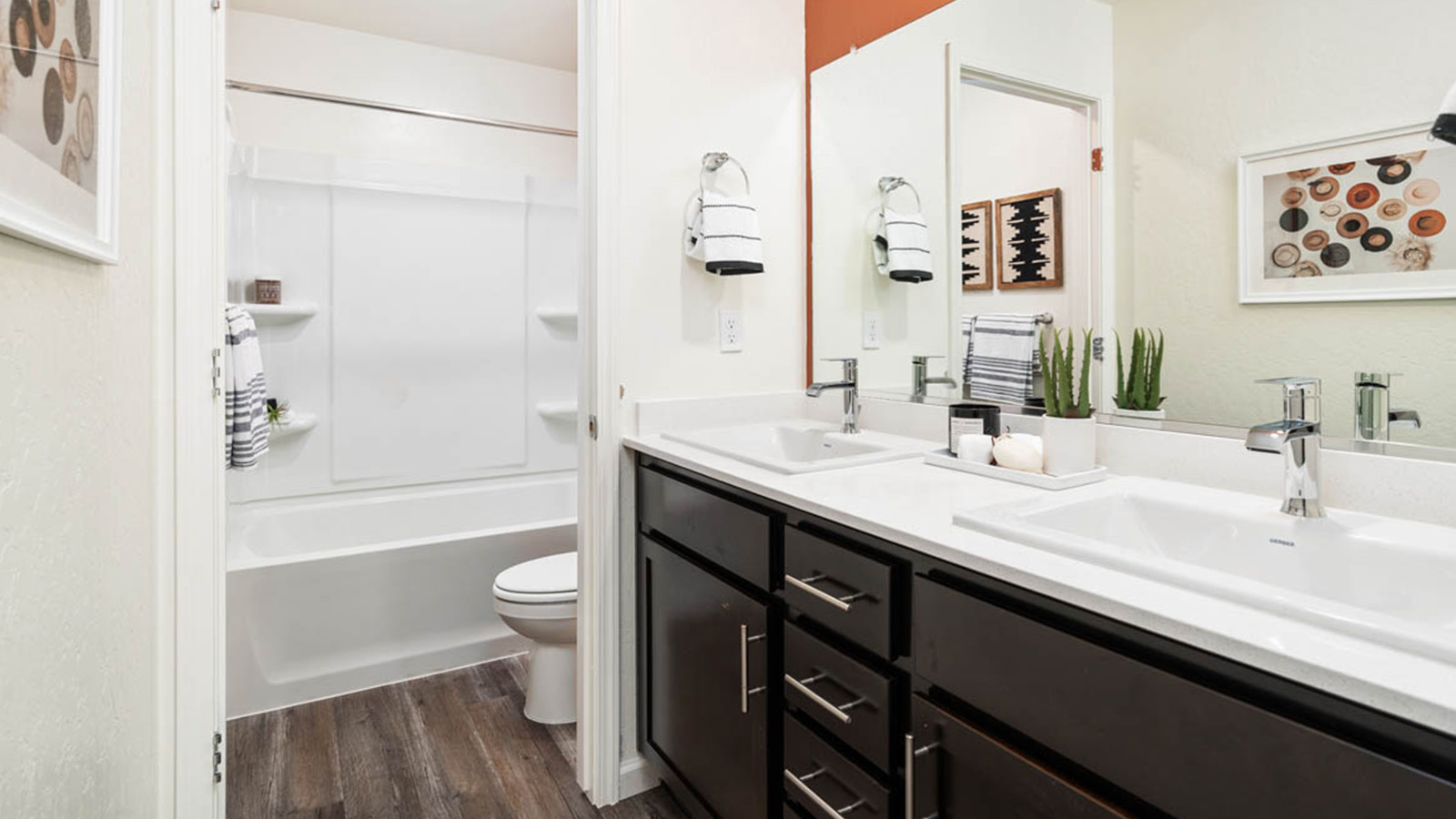 Guest bath with brown cabinets.