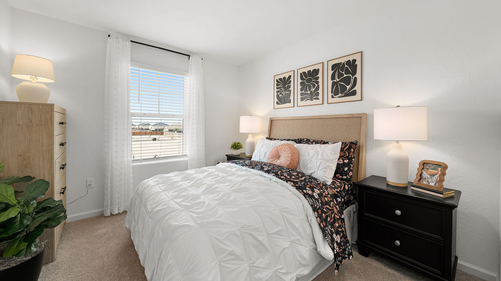 Bedroom with flower accents on the bed and walls.