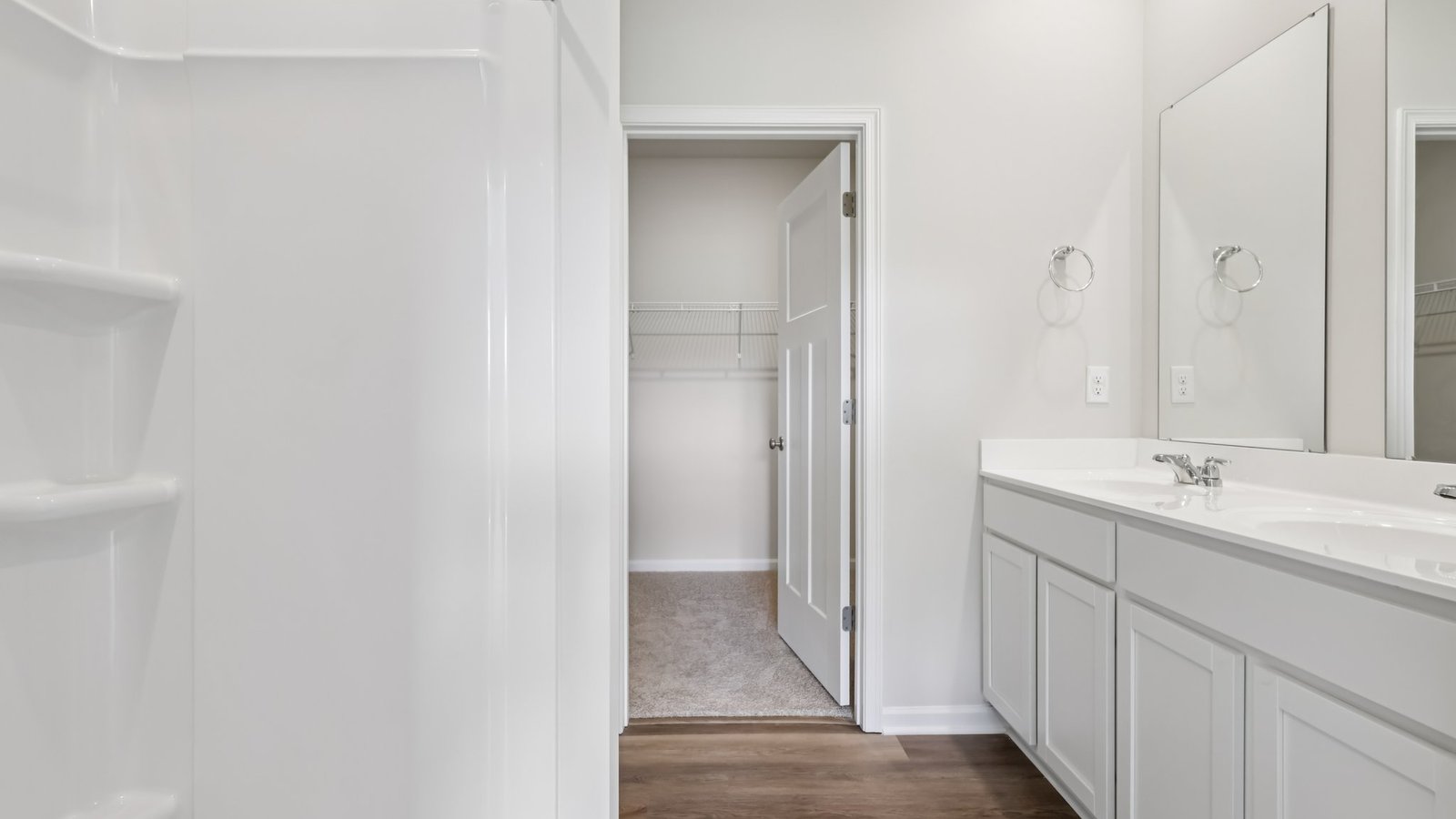 Primary ensuite with white countertops