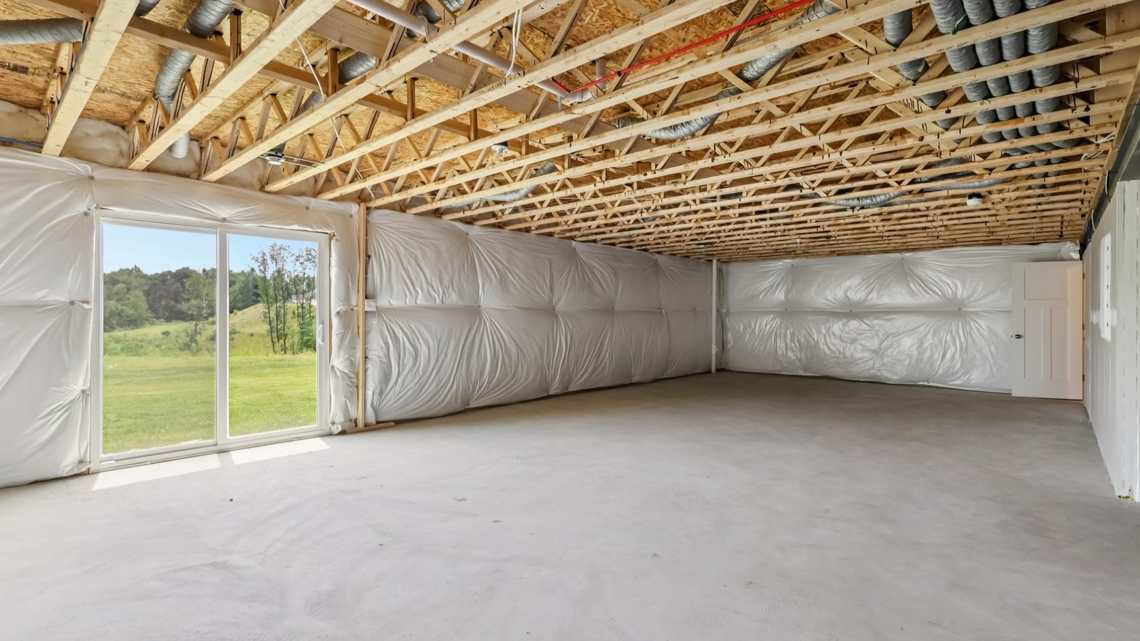 Unfinished basement with sliding glass door