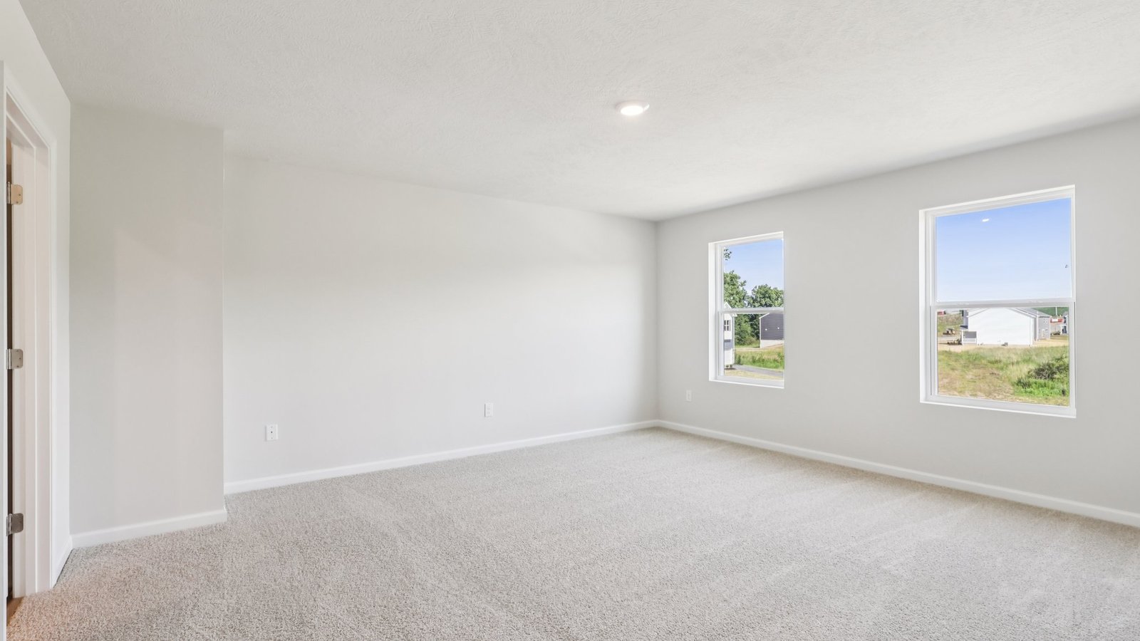 Primary bedroom with two windows