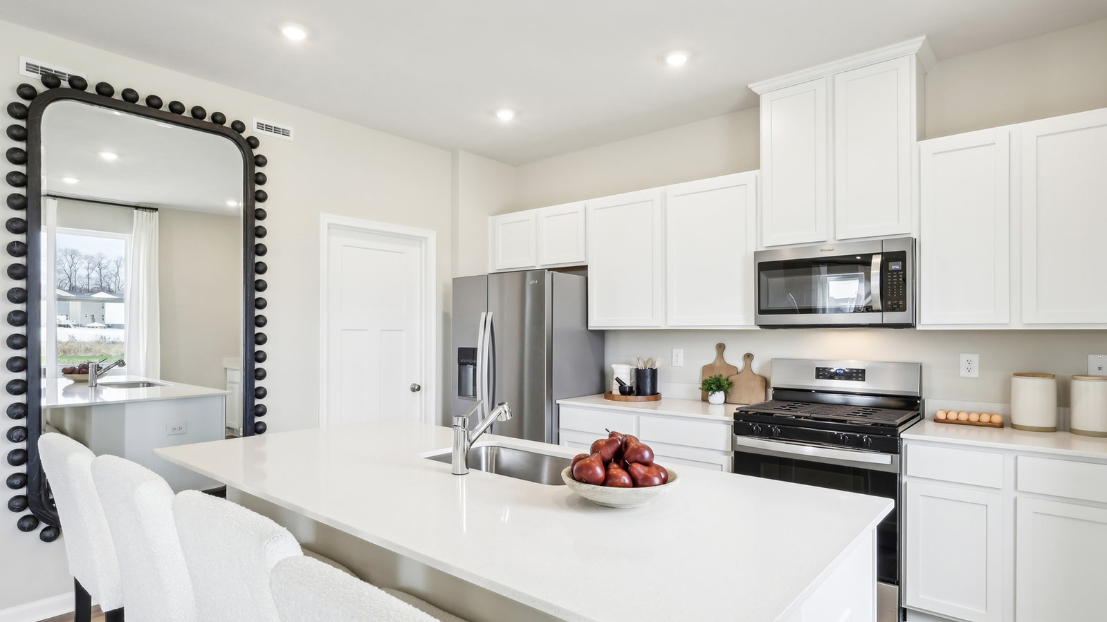 Kitchen area with white cabinets and countertops