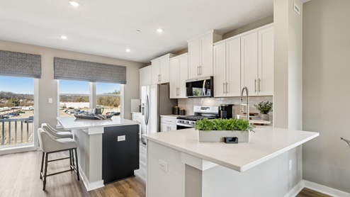 Kitchen with white cabinets and quartz countertops throughout