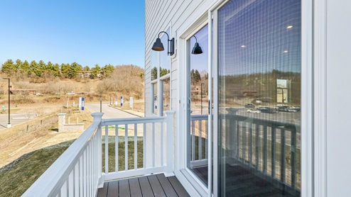 Sliding glass door with cantilever deck off of kitchen