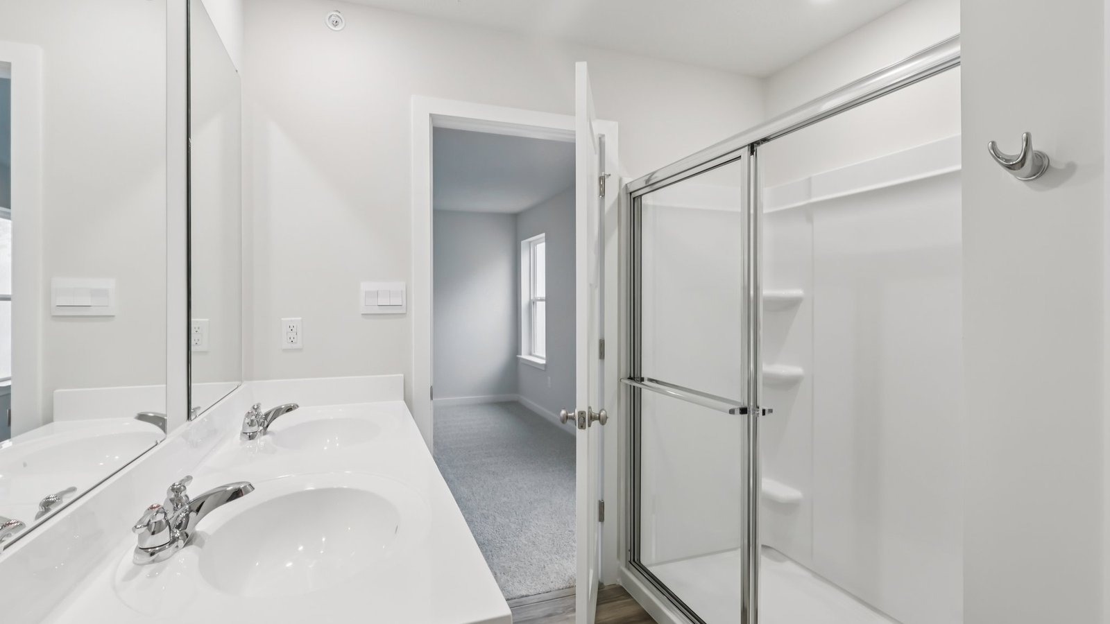 primary bedroom ensuite bathroom with glass shower door