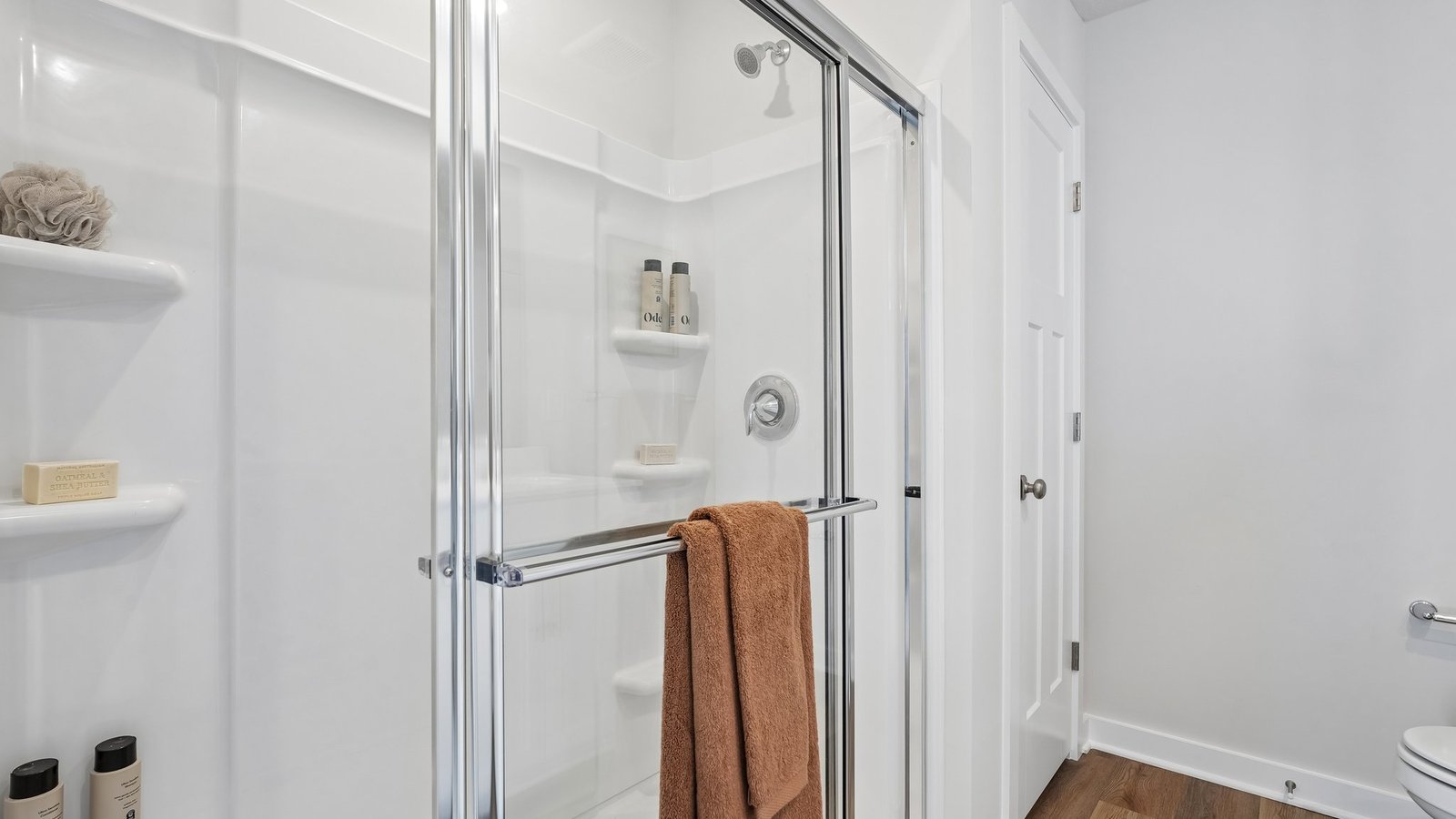 Primary ensuite bathroom sliding glass shower door