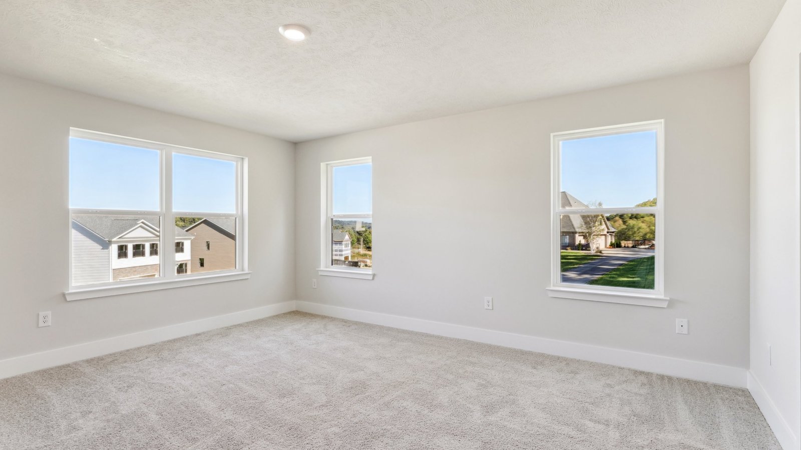 Primary bedroom with large windows