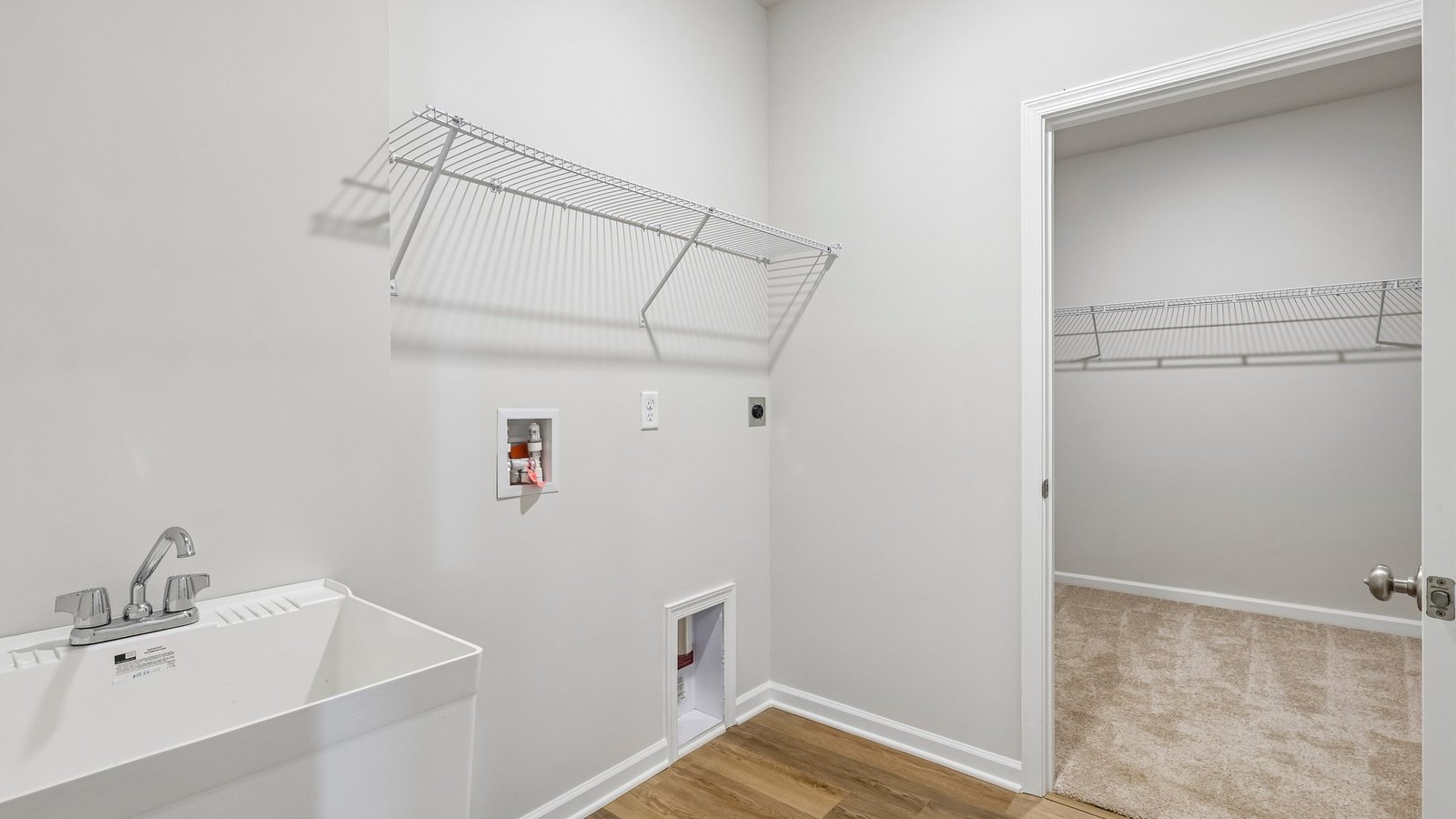 Laundry room off of primary walk-in closet