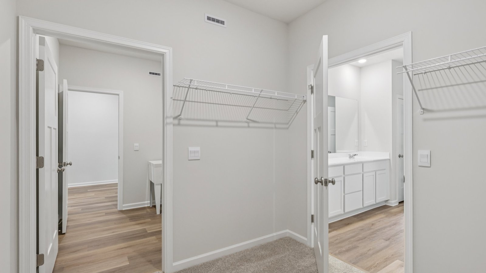 Primary bedroom walk-in closet off of ensuite bathroom