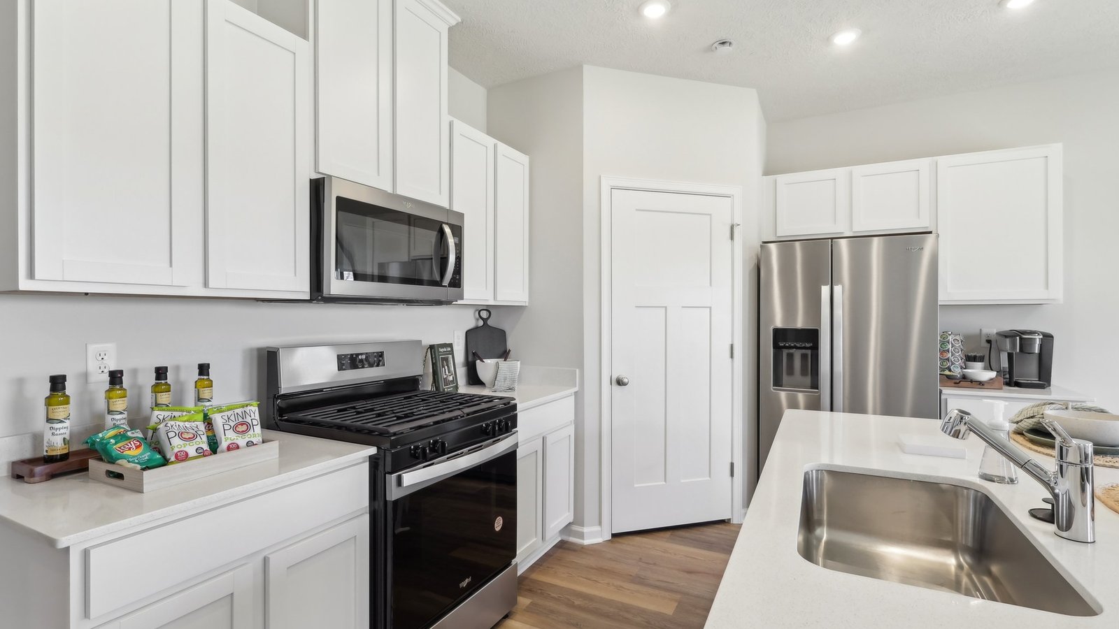 Kitchen with white cabinets and countertops