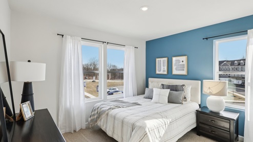 secondary bedroom with three large windows