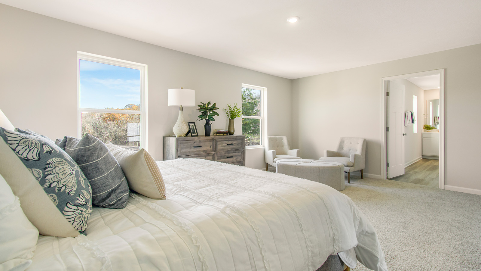 primary bedroom with large windows and a lot of natural lighting