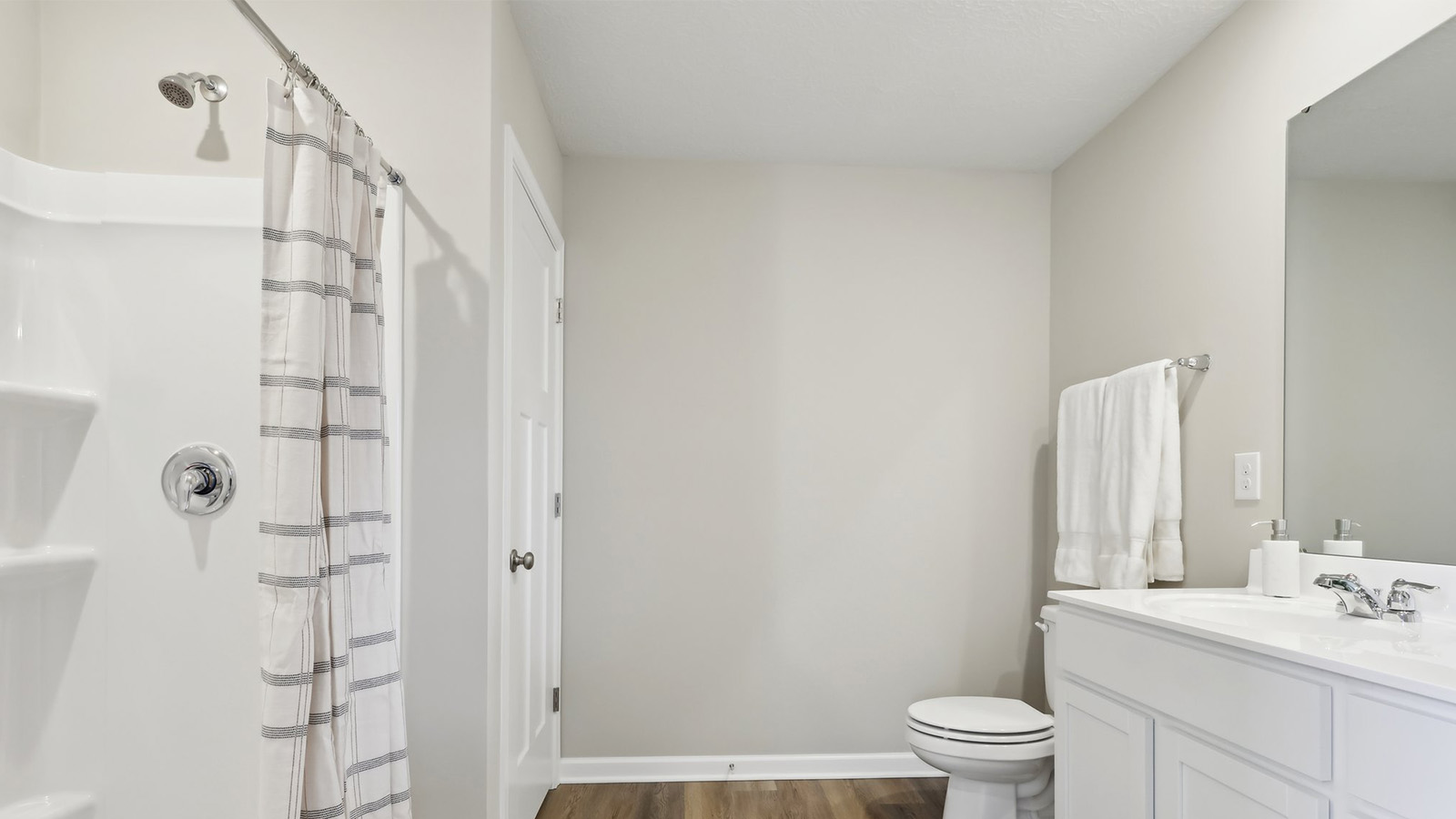 Primary ensuite with white countertops