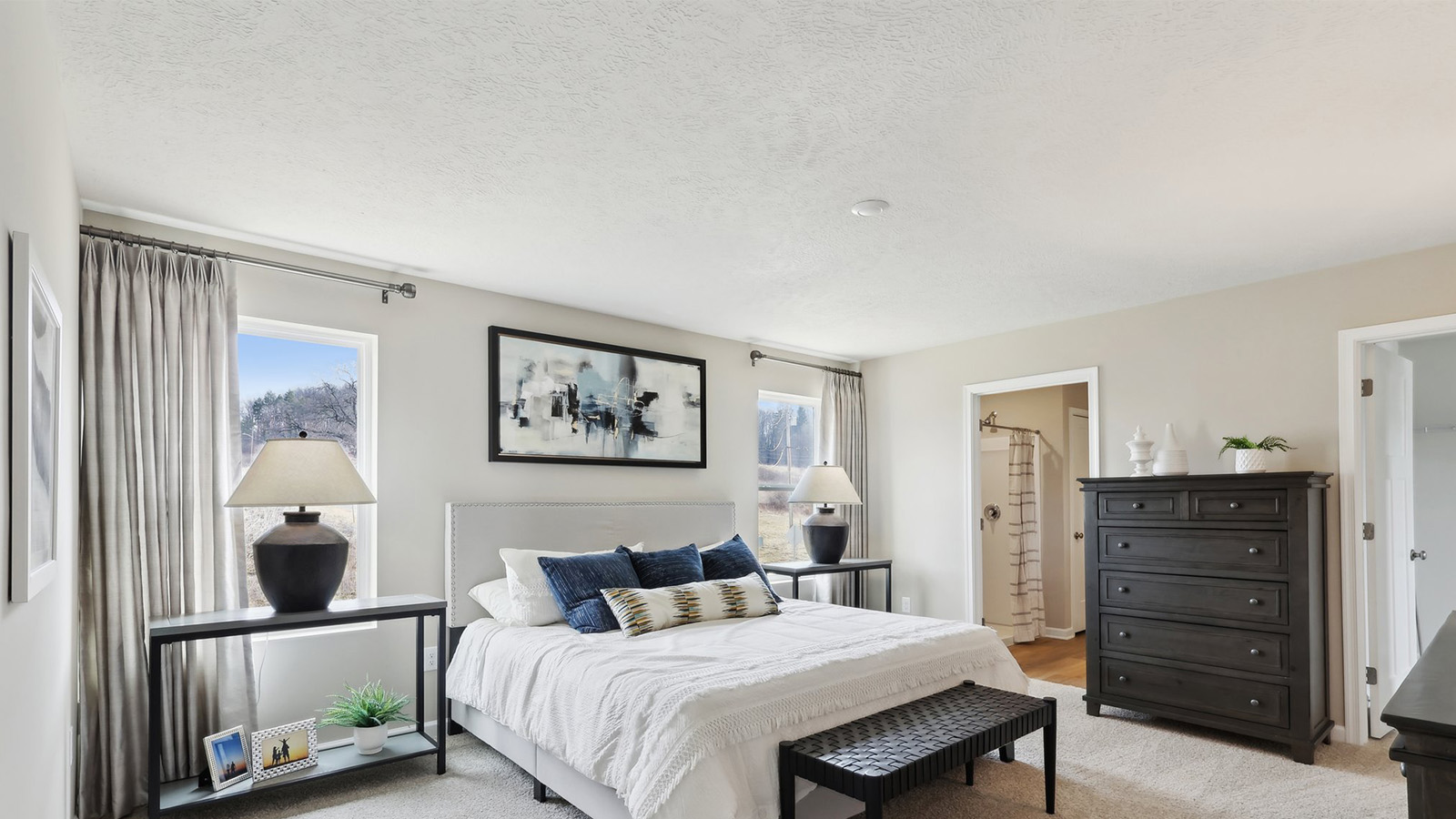 Primary bedroom with large windows