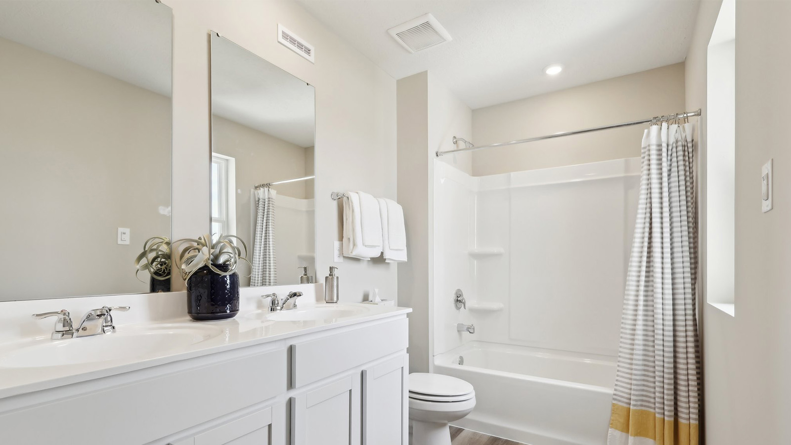 Secondary full bath with white countertops