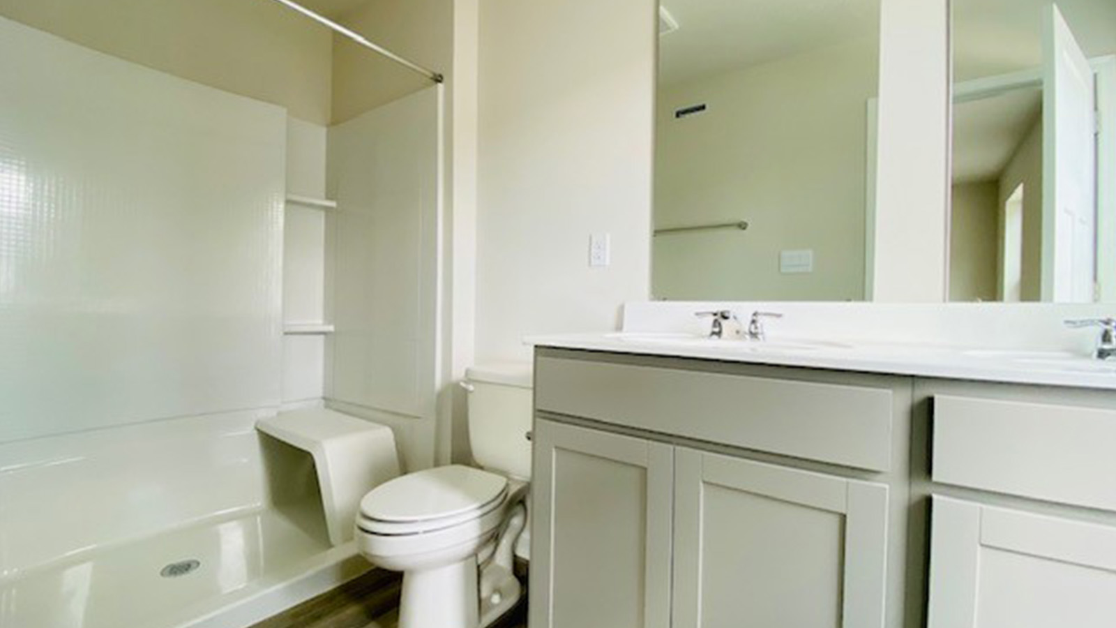 primary ensuite bathroom with grey cabinets