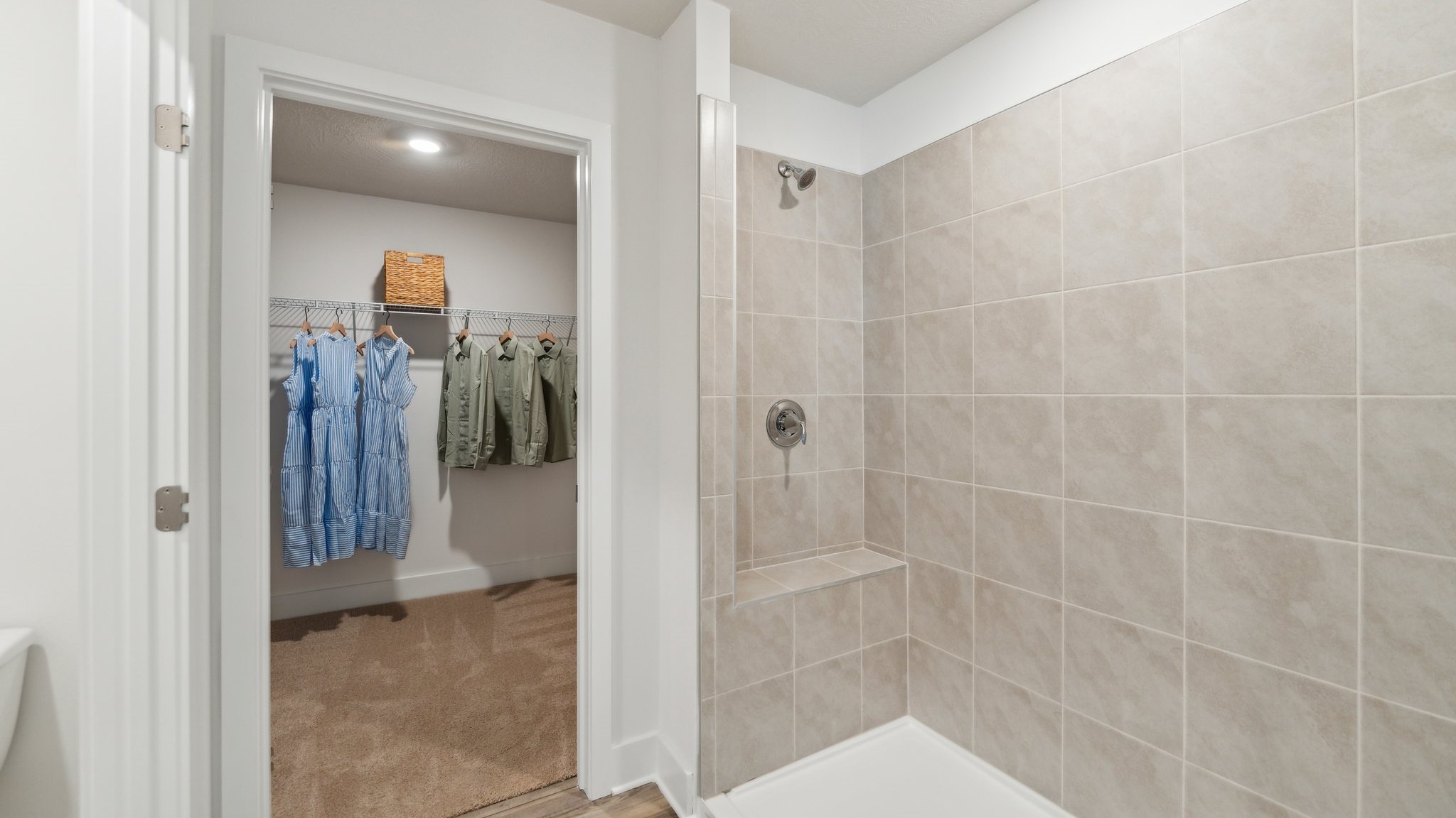 Primary ensuite shower with walk-in closet
