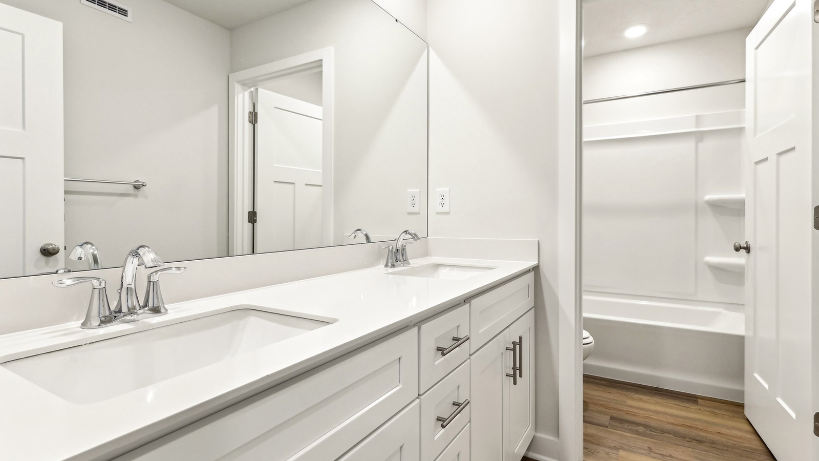Secondary full bathroom with dual sink vanity