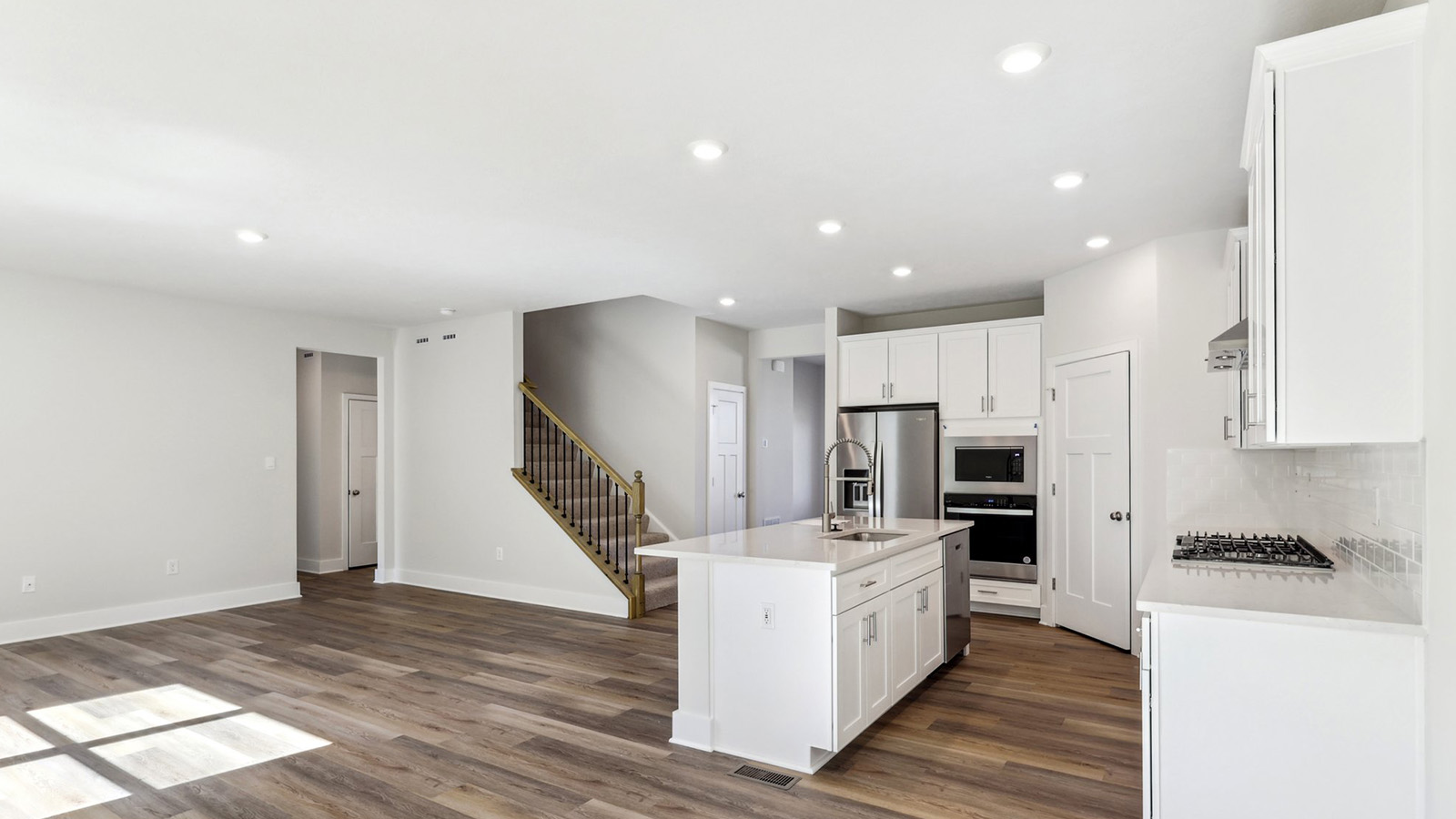 Main level with connected kitchen, dining, and living area