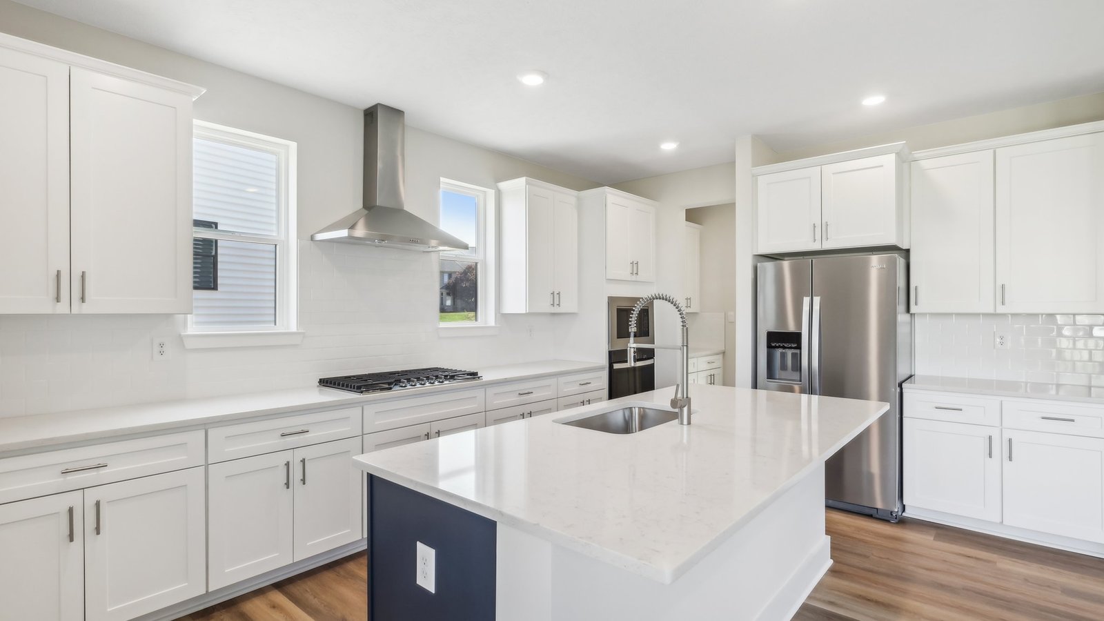 Kitchenw ith white cabinets and counterops