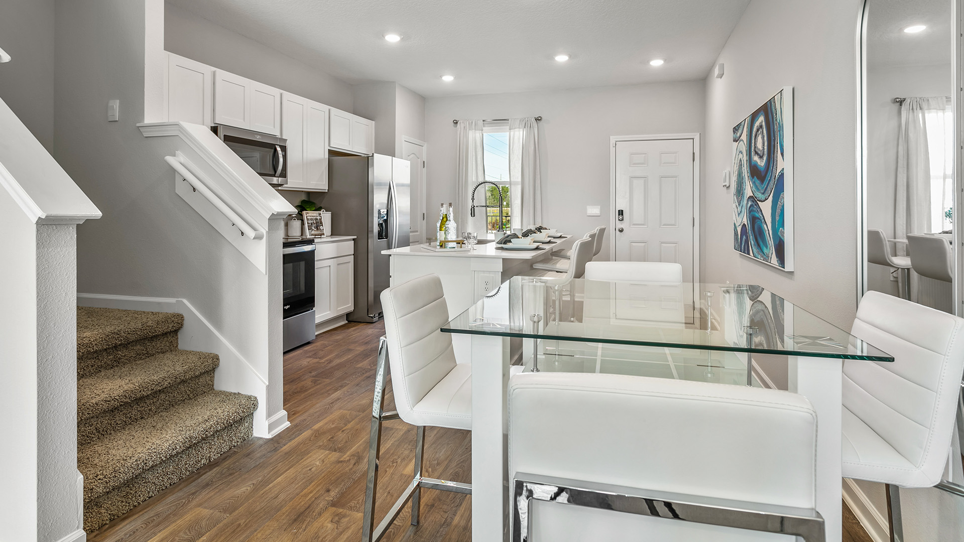 Interior dining area with stairs and kitchen