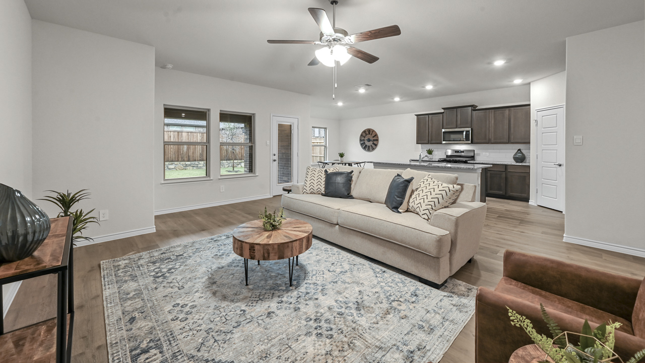 living area with natural light hardwood floors and large windows