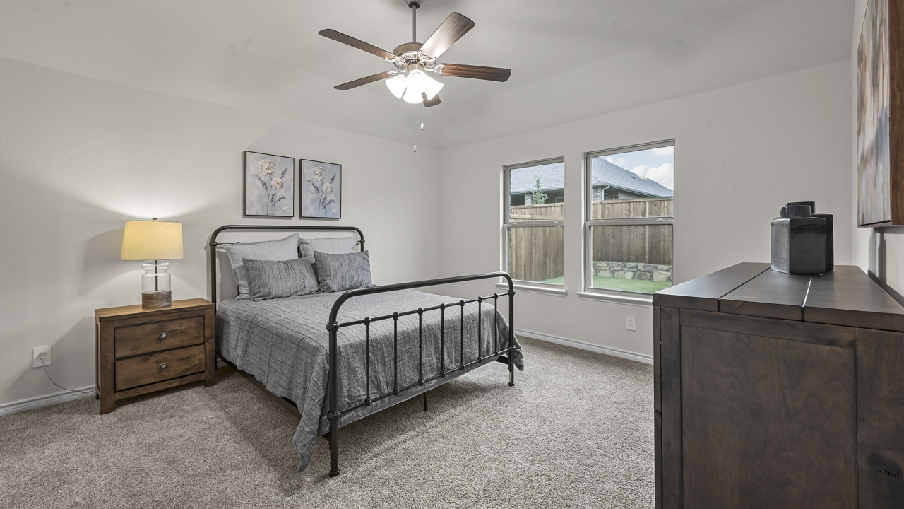 primary bedroom with large windows providing natural light