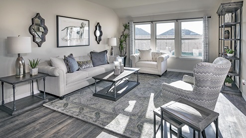 living area with large windows and beautiful gray furniture