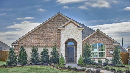 Single story model home exterior with brown brick and white stone with a green lawn and shrubbery