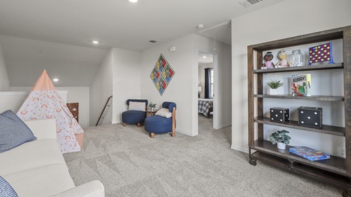 upsatirs gameroom with furniture