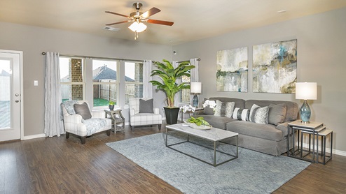 large open concept living room with ceiling fan and large windows
