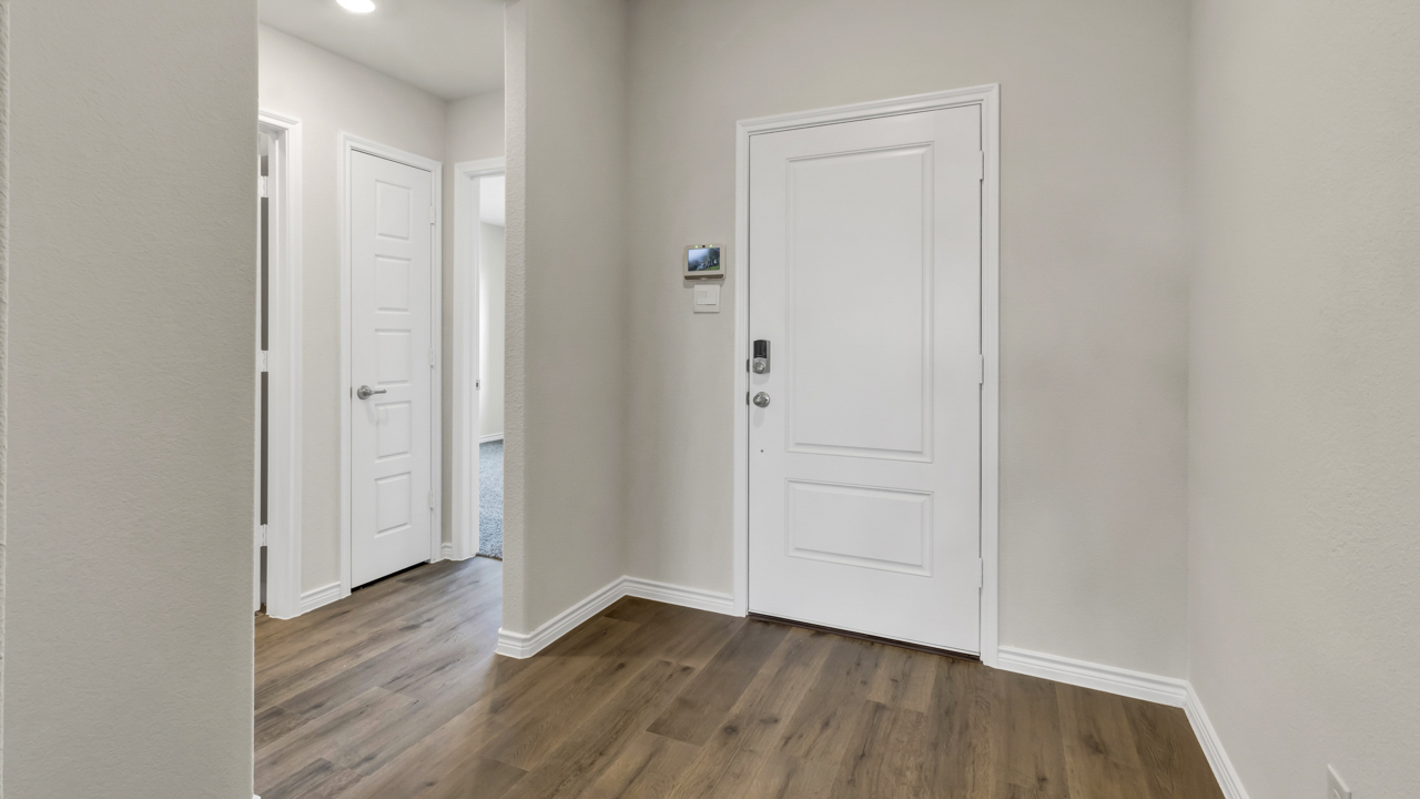interior entry view of front door and adjacent hallway