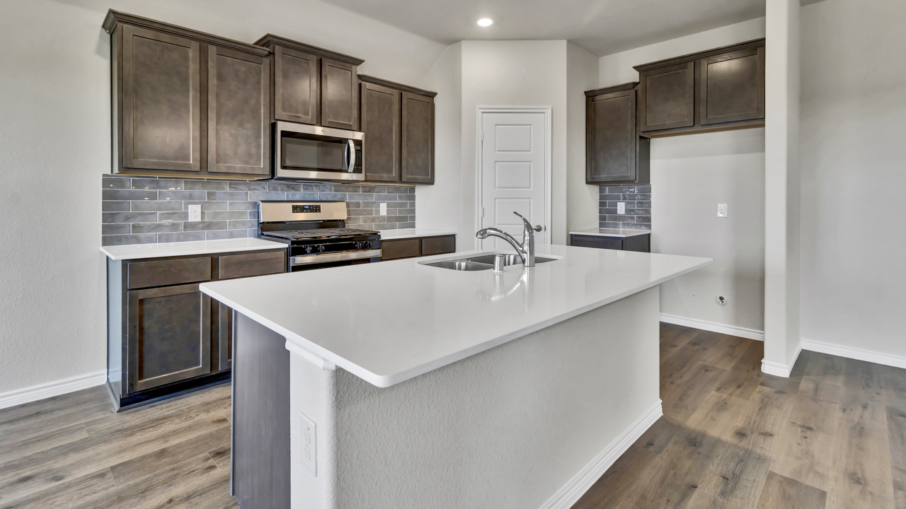 kitchen with brown cabinets and large island