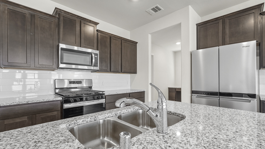 a kitchen with dark cabinets