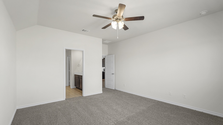 an empty bedroom with gray carpet