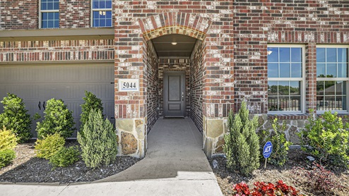5044 Blazer Way at Fireside by the Lake in Garland, TX exterior entrance of two story model home