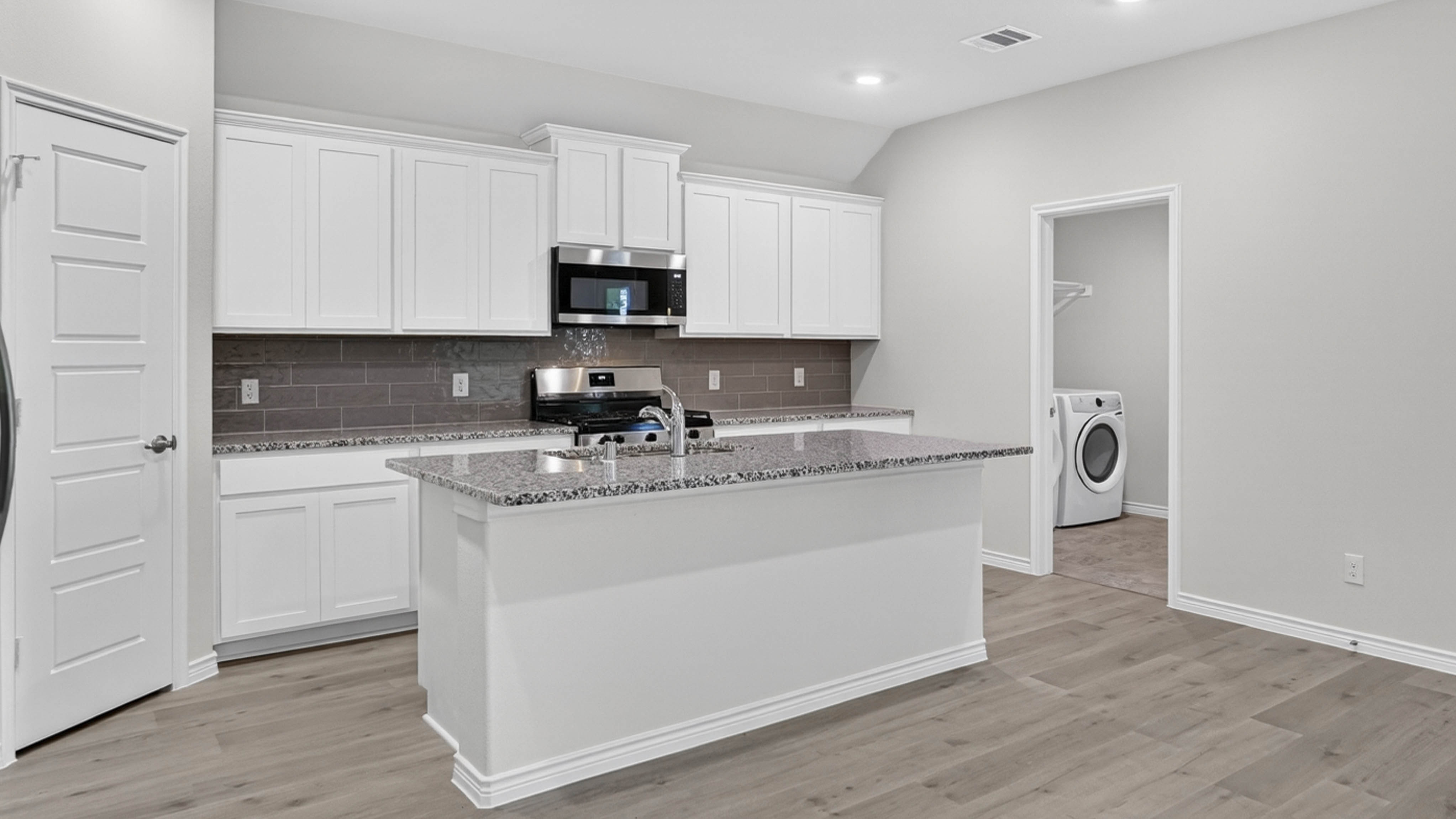 kitchen area with white cabinets and granite counters