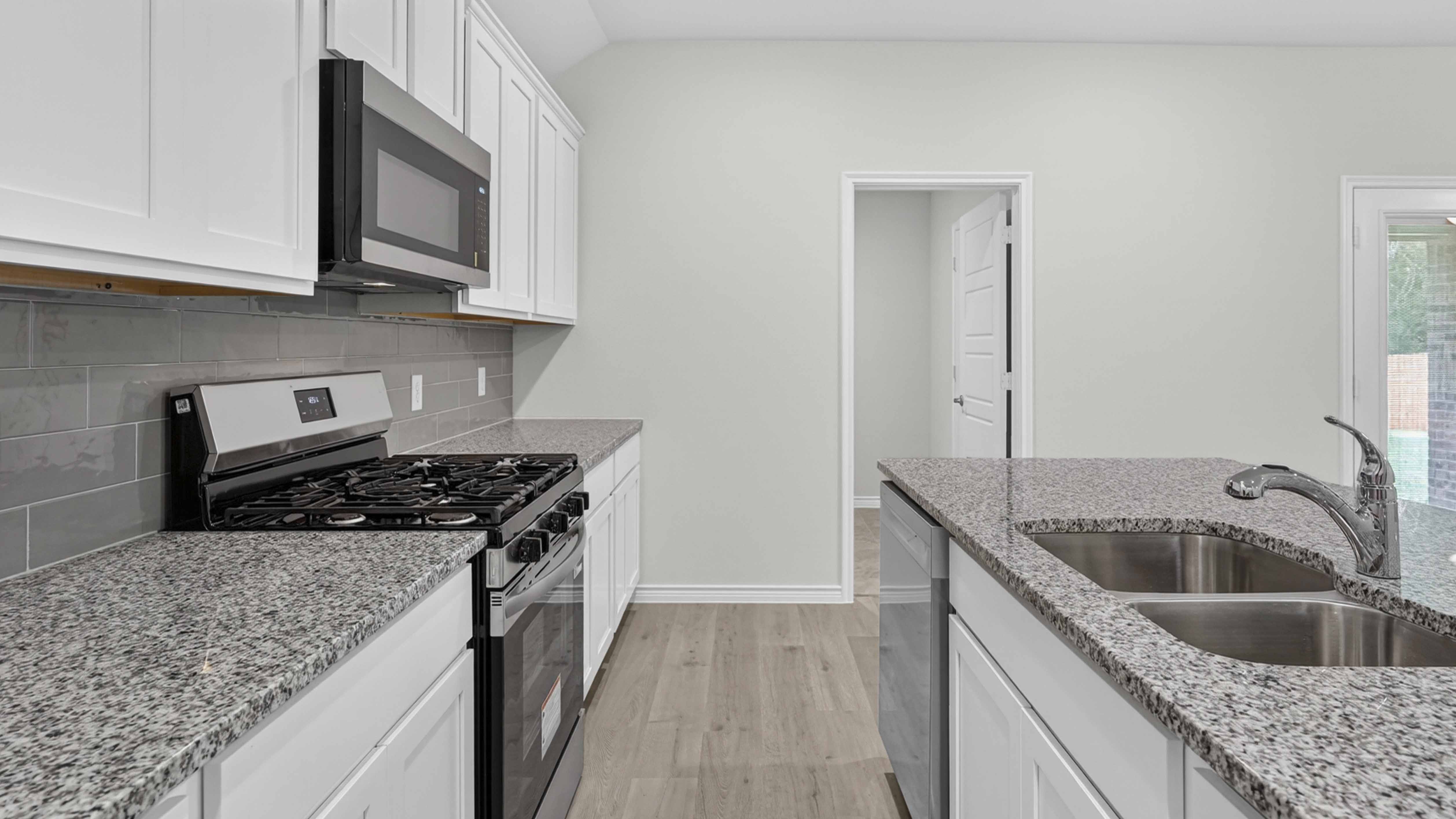 kitchen area with white cabinets and granite counters