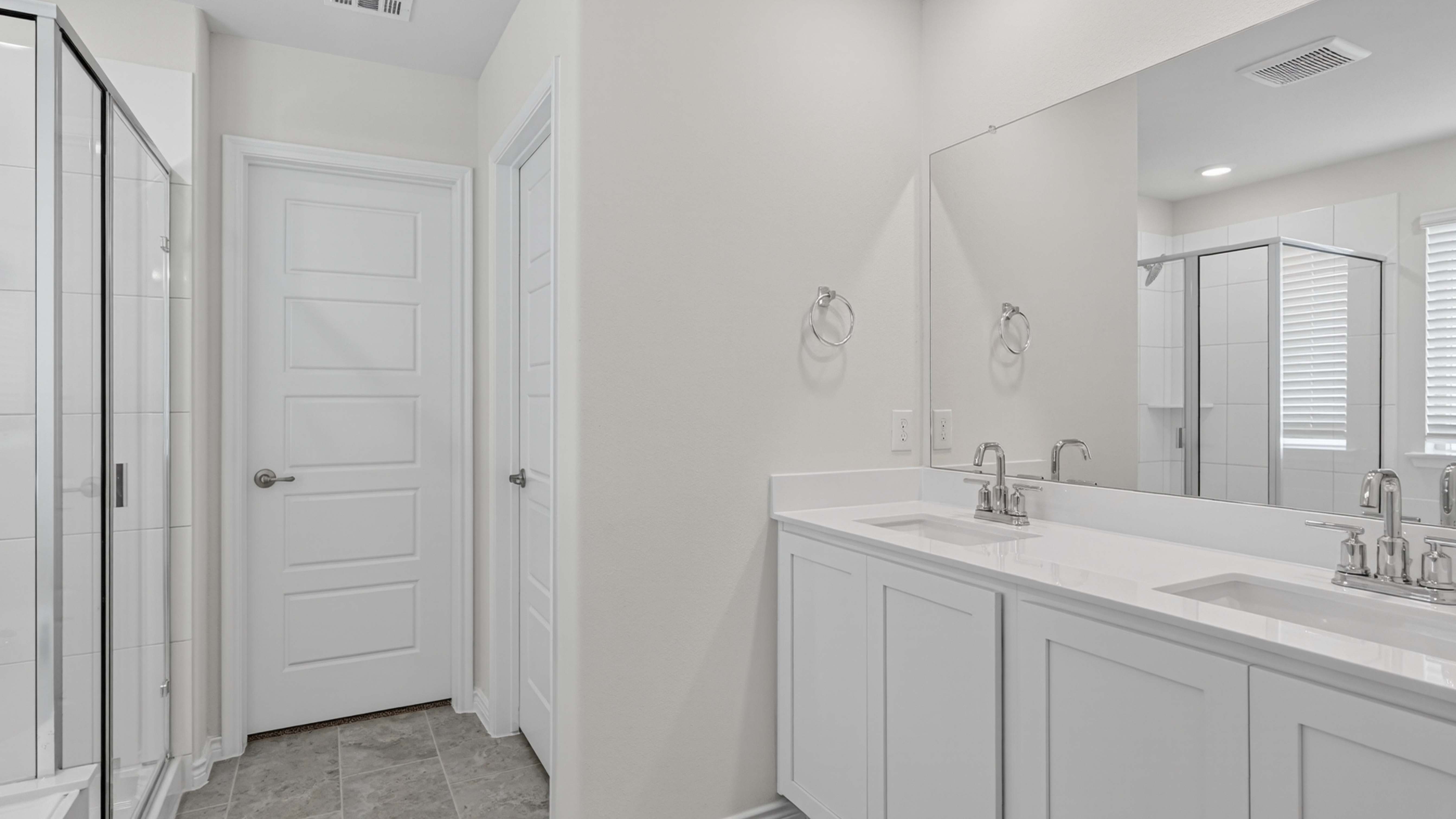 primary bathroom with white counters and cabinets