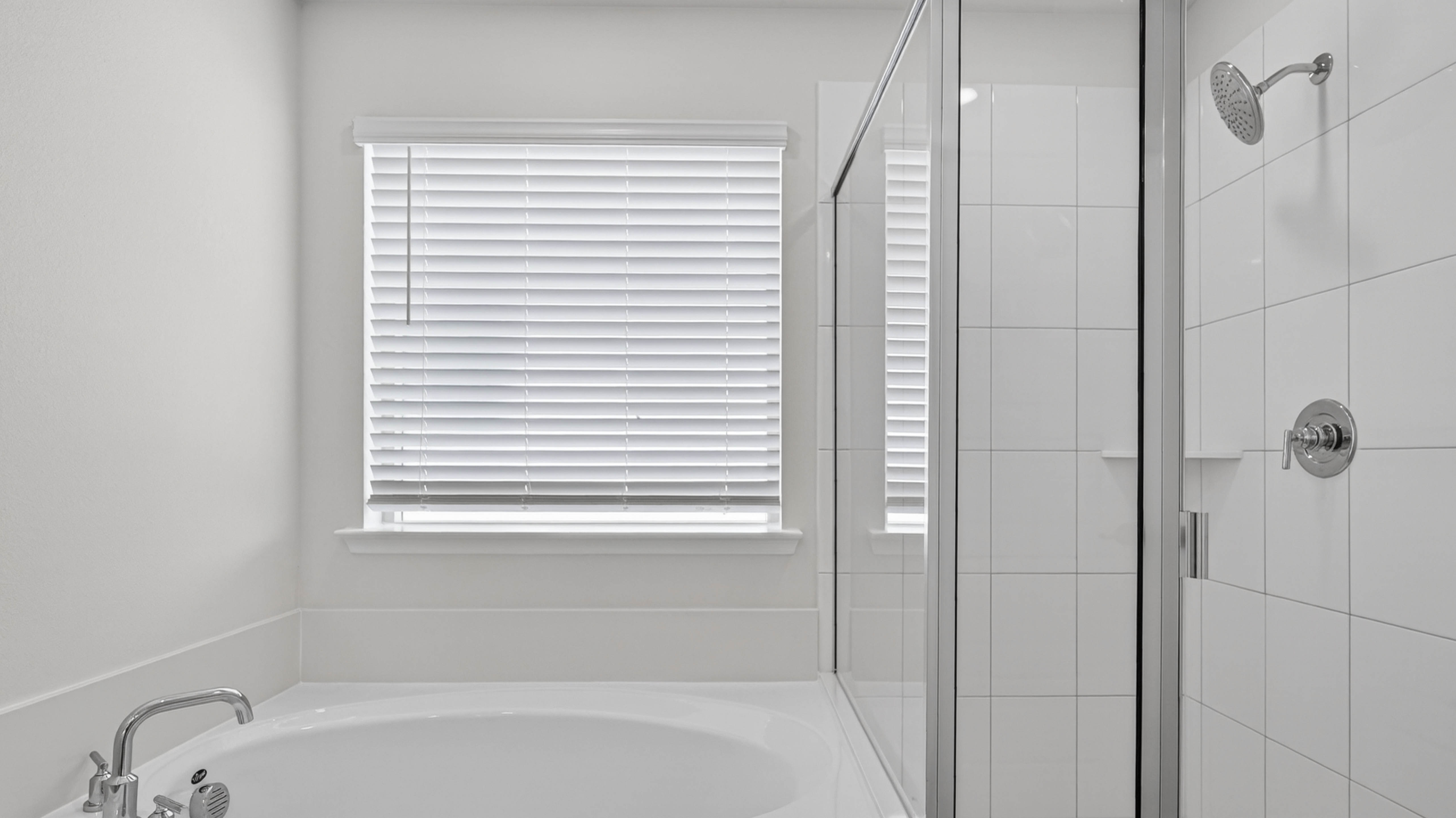 primary bathroom with white counters and cabinets