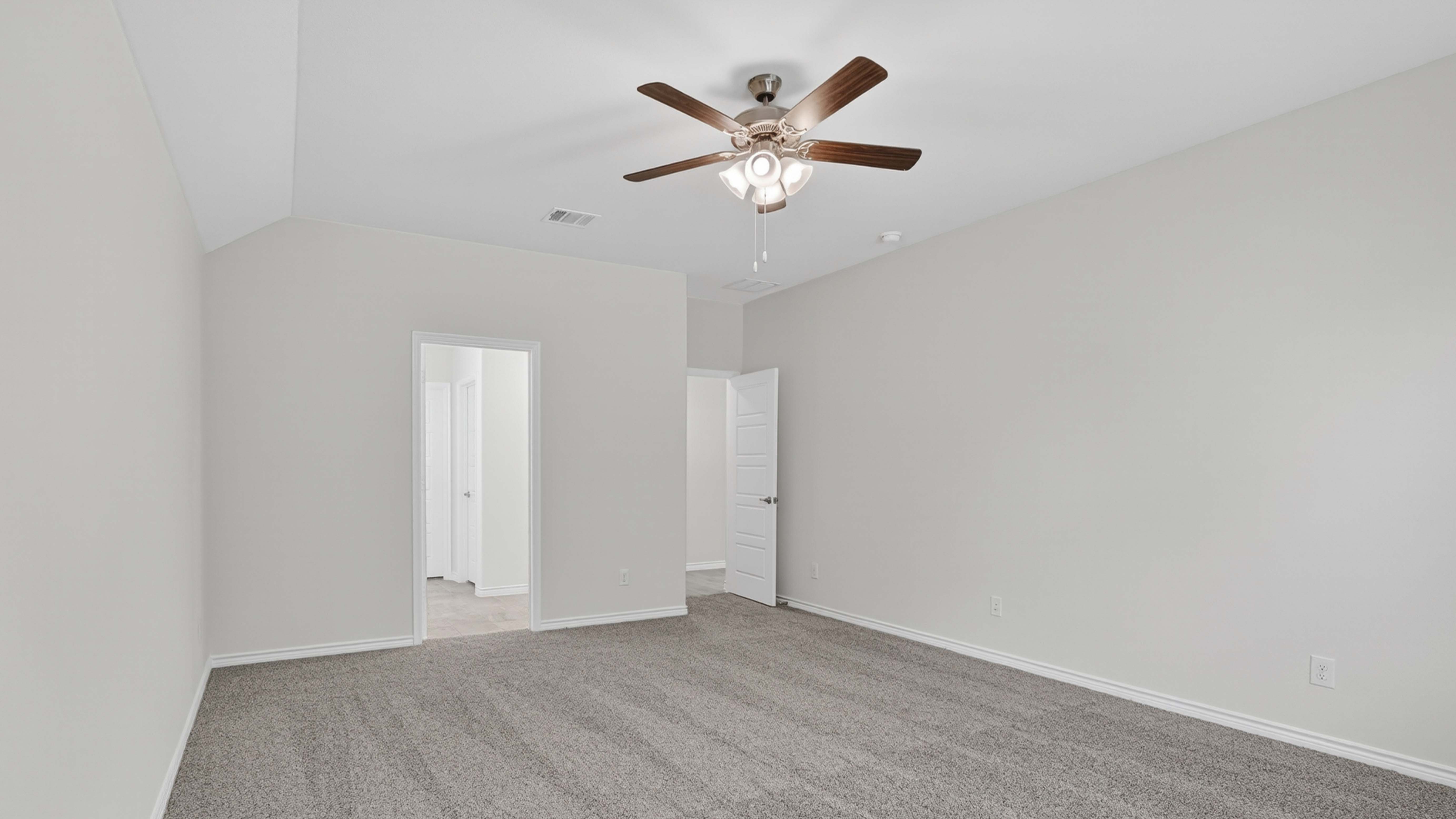 primary bedroom with large windows facing the backyard