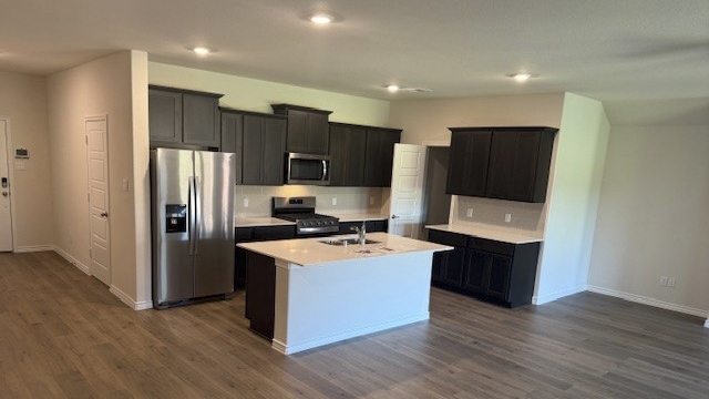 kitchen area with hardwood floors and light colored counters