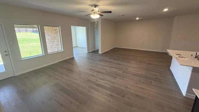open concept living and dining area with hardwood floors
