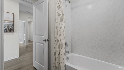 1304 Quest Bridge Road half bathroom with white bathtub and granite walls