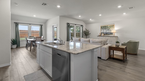 1304 Quest Bridge Road Model granite kitchen island with view of open concept living area and dining area