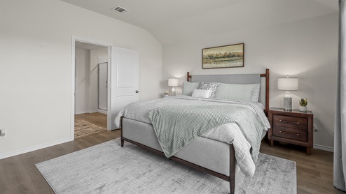1304 Quest Bridge Road primary bedroom with natural lighting and hardwood floors