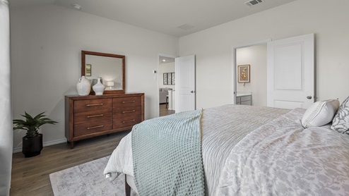 1304 Quest Bridge Road primary bedroom with king sized bed and natural lighting with hardwood floors